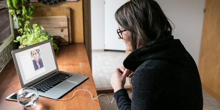 Woman in an online meeting on a laptop