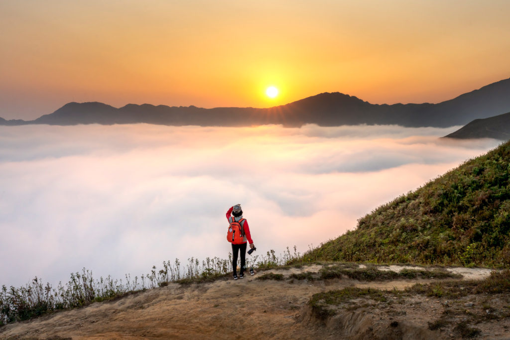 Person on a mountaintop in the clouds